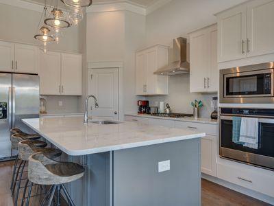 7 Grande Pointe Dr Inlet Beach Inlet Beach, FL 32461 - Photo 23 of 61 a kitchen with stainless steel appliances a sink a stove a refrigerator and cabinets