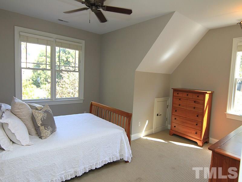 1405 Jarvis Street Raleigh, NC 27608 - Photo 17 of 25 a bedroom with a bed and a dresser