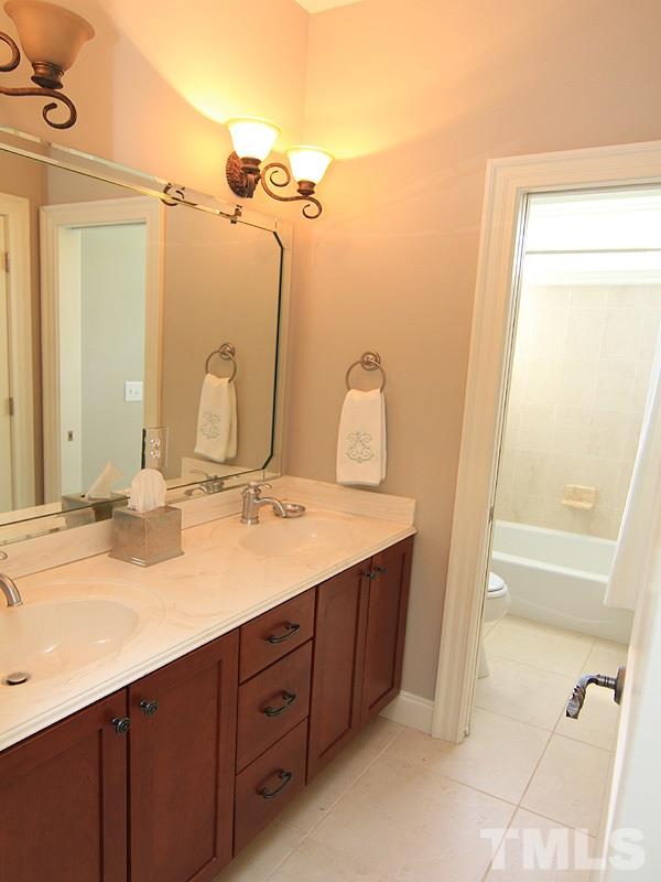 1405 Jarvis Street Raleigh, NC 27608 - Photo 19 of 25 a bathroom with a double vanity sink and a mirror