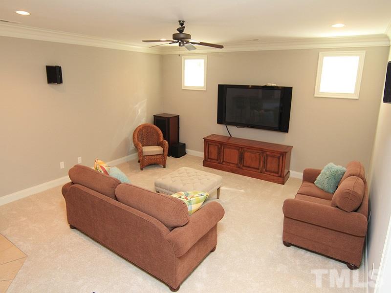1405 Jarvis Street Raleigh, NC 27608 - Photo 20 of 25 a living room with furniture and a flat screen tv