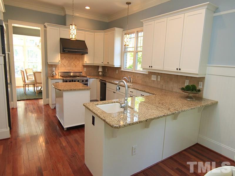 1405 Jarvis Street Raleigh, NC 27608 - Photo 6 of 25 a kitchen with stainless steel appliances granite countertop a sink stove and refrigerator