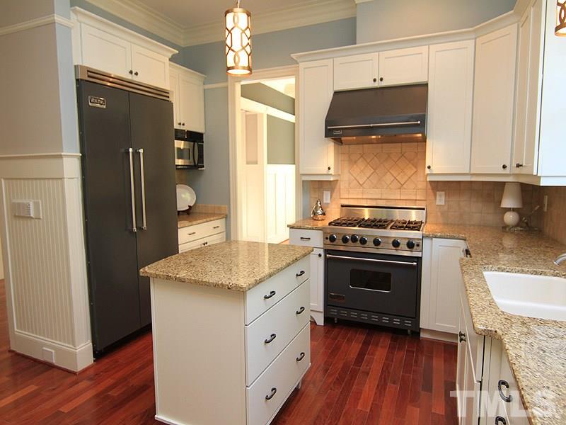 1405 Jarvis Street Raleigh, NC 27608 - Photo 8 of 25 a kitchen with stainless steel appliances a stove a sink and a refrigerator