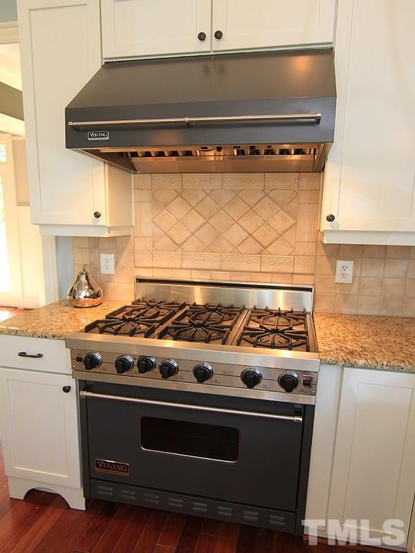1405 Jarvis Street Raleigh, NC 27608 - Photo 9 of 25 a stove top oven sitting inside of a kitchen