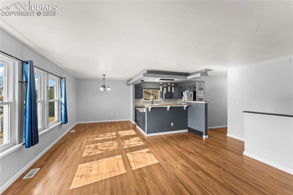 526 Griffith Way Colorado Springs, CO 80911 - Photo 12 of 46 a room with kitchen island wooden floors and stainless steel appliances