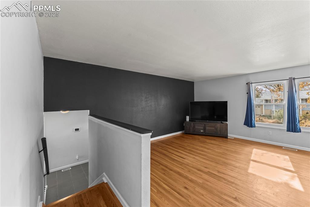 526 Griffith Way Colorado Springs, CO 80911 - Photo 13 of 46 a bedroom with a bed and a flat screen tv