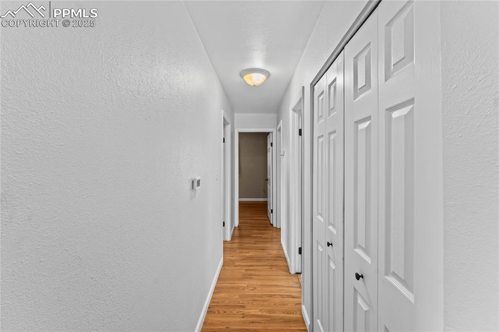 526 Griffith Way Colorado Springs, CO 80911 - Photo 15 of 46 a view of a hallway with wooden floor