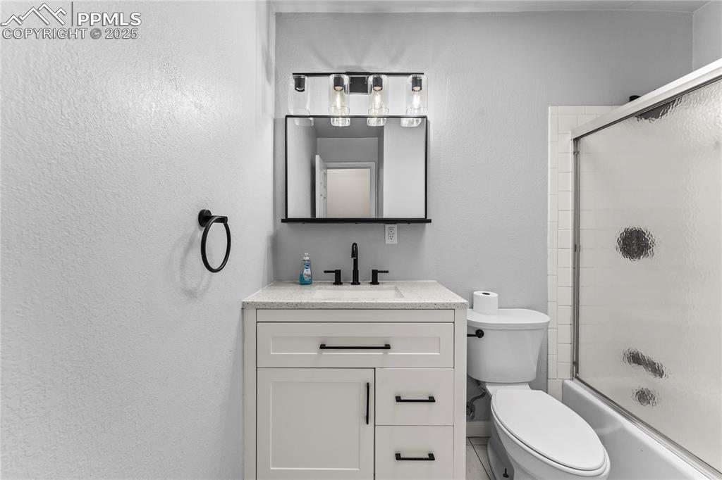 526 Griffith Way Colorado Springs, CO 80911 - Photo 16 of 46 a bathroom with a toilet sink vanity and mirror