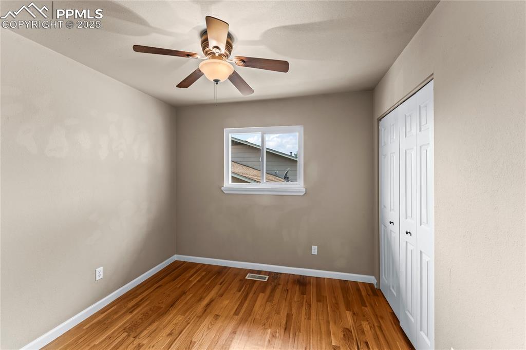 526 Griffith Way Colorado Springs, CO 80911 - Photo 22 of 46 wooden floor in an empty room with a window