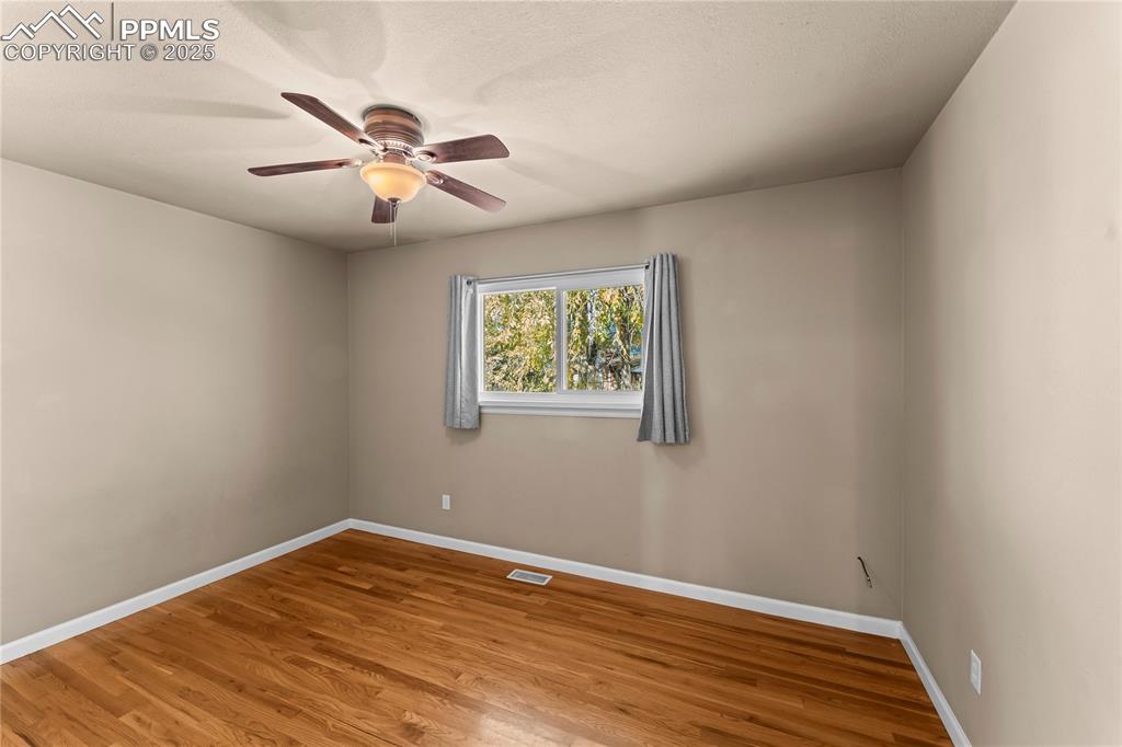 526 Griffith Way Colorado Springs, CO 80911 - Photo 24 of 46 wooden floor in an empty room with a window