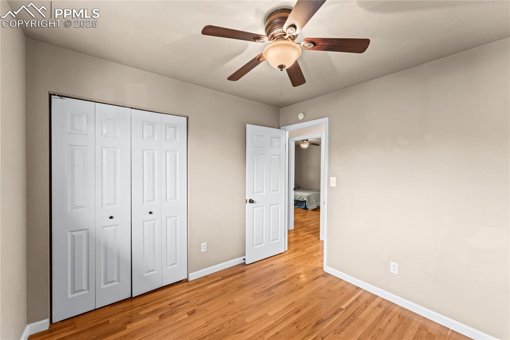 526 Griffith Way Colorado Springs, CO 80911 - Photo 25 of 46 an empty room with wooden floor fan and windows