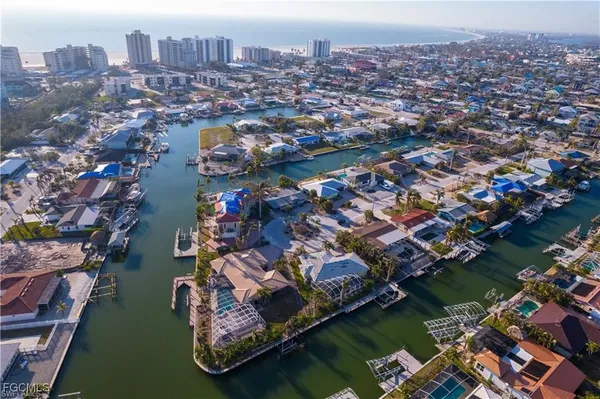 an aerial view of residential houses with outdoor space and lake view