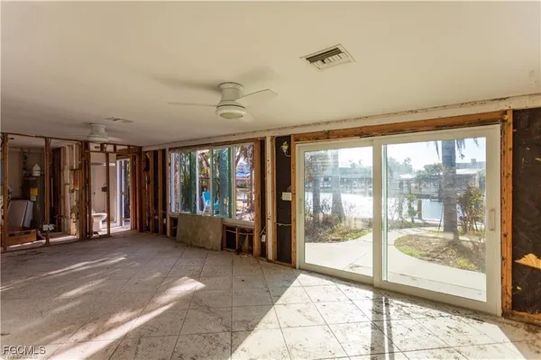 a living room with furniture and large windows