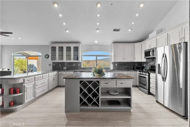 a kitchen with stainless steel appliances granite countertop a stove and a refrigerator