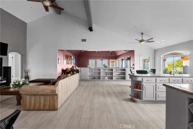 a living room with furniture a window and a chandelier