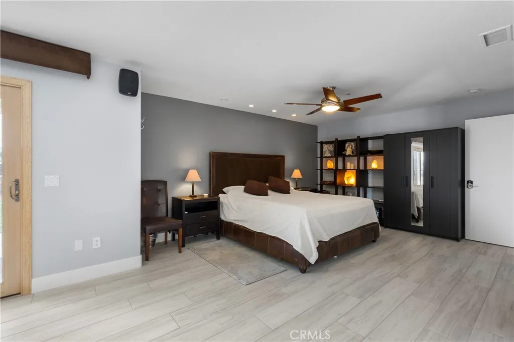 31800 Diamond View Lane Agua Dulce, CA 91390 - Photo 33 of 36 a spacious bedroom with a bed and a large mirror