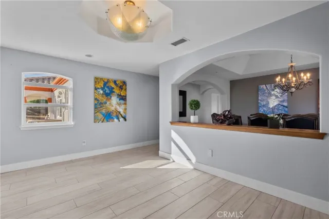a view of a livingroom with wooden floor and a large window