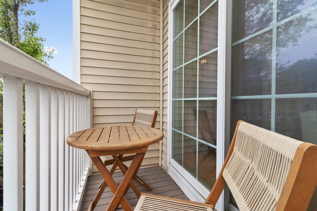 29 Spruce Street, Unit 23 Waltham, MA 02453 - Photo 24 of 26 a view of a balcony with table and chairs