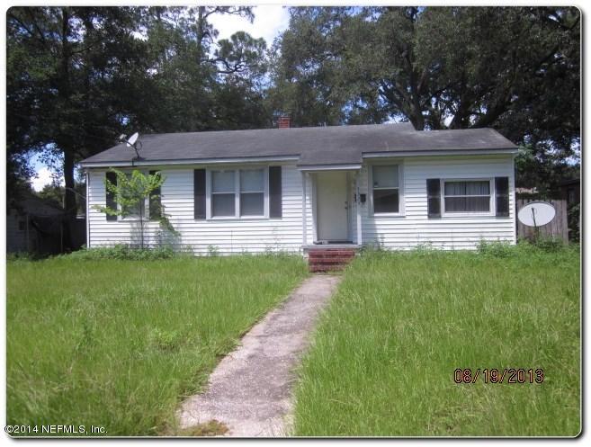 a front view of a house with a garden and yard