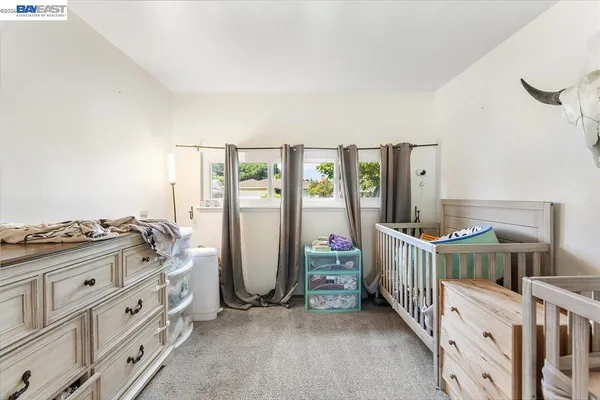 a bedroom with furniture and baby crib