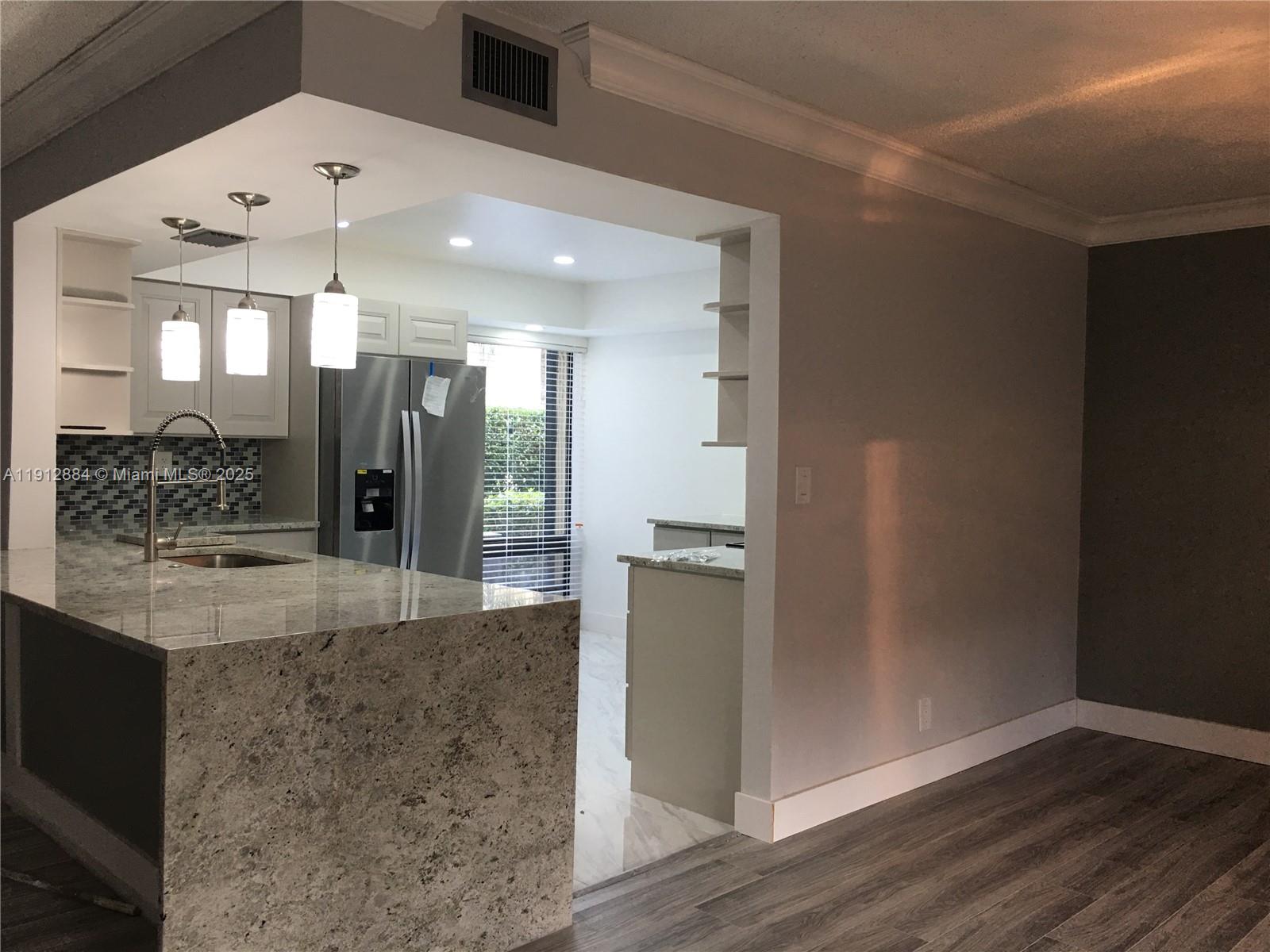 a view of a kitchen cabinets and chandelier