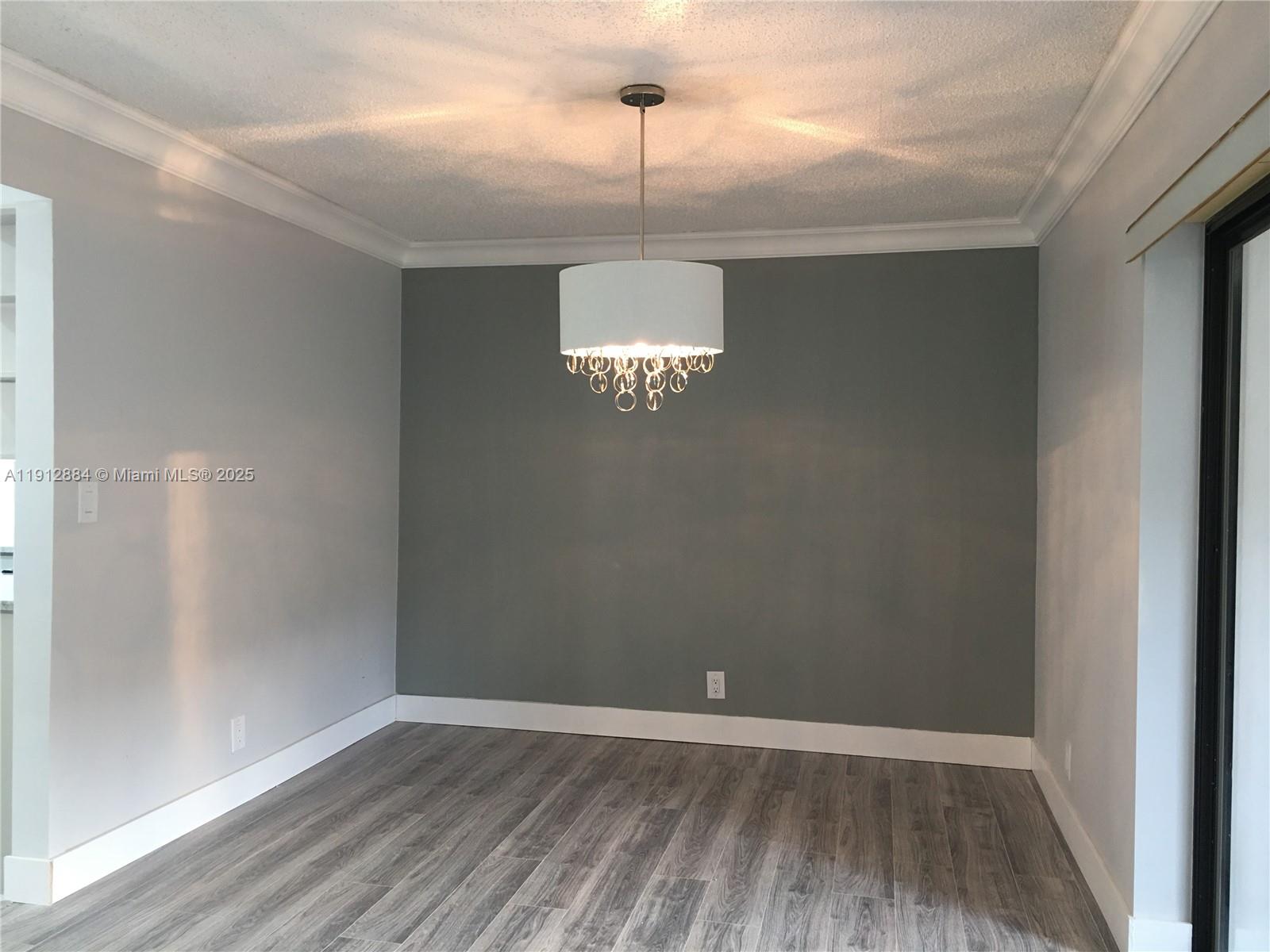 Boca del Mar Boca Raton, FL 33433 - Photo 3 of 6 a view of an empty room with window and wooden floor