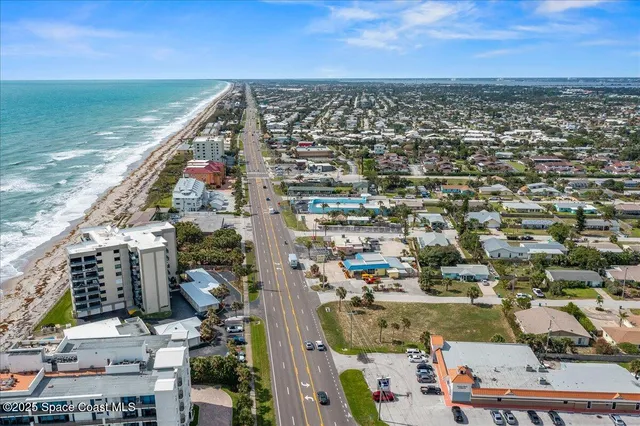 an aerial view of residential building and ocean