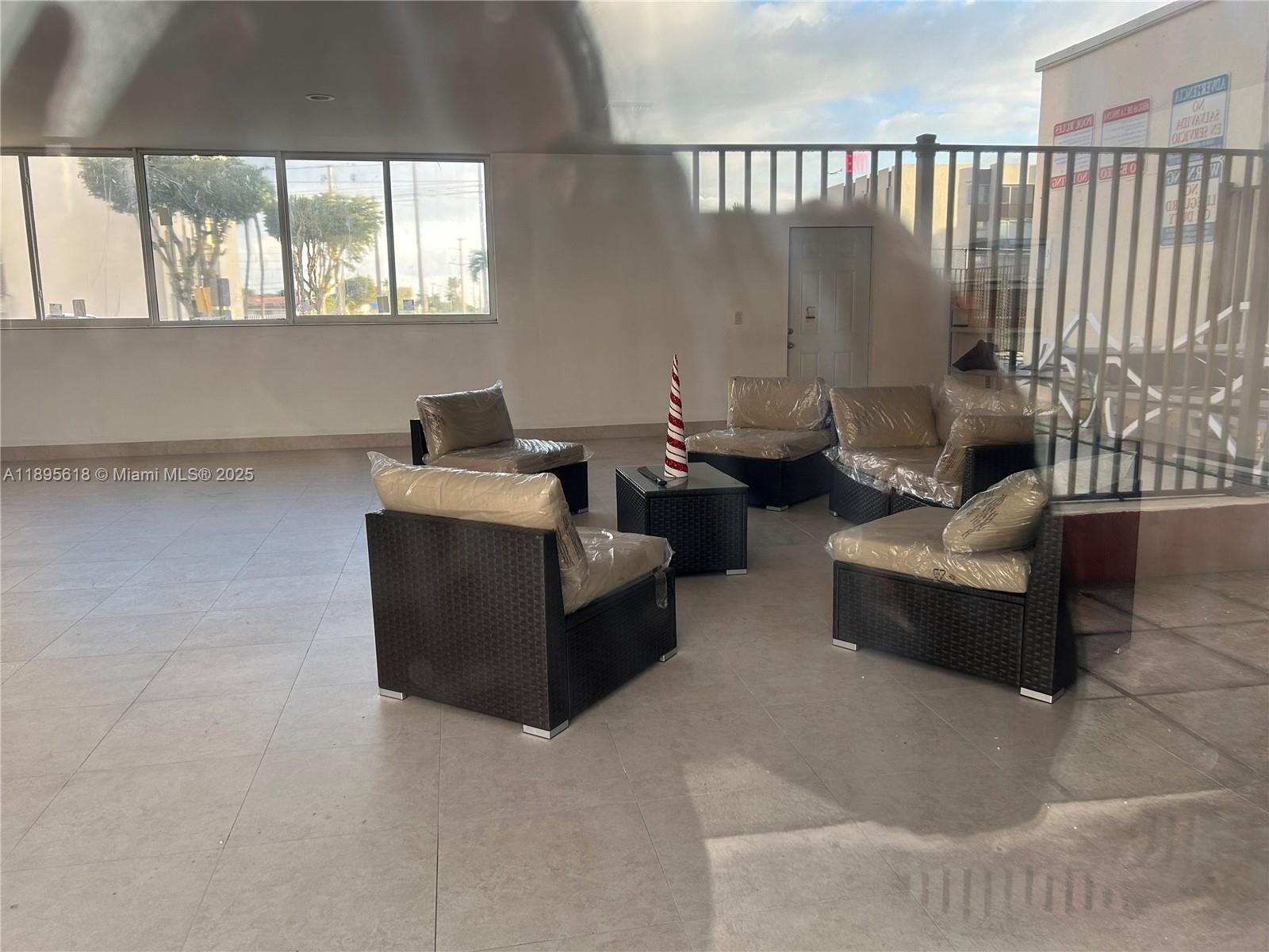 9411 Southwest 4th Street, Unit 202 Miami, FL 33174 - Photo 14 of 20 a living room with furniture and a window