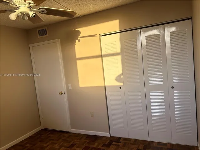 a view of a kitchen with furniture and large windows