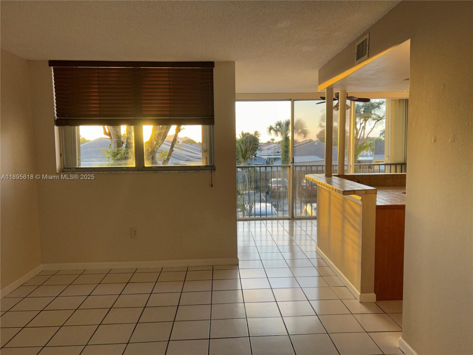 9411 Southwest 4th Street, Unit 202 Miami, FL 33174 - Photo 19 of 20 a view of empty room with wooden floor and fan