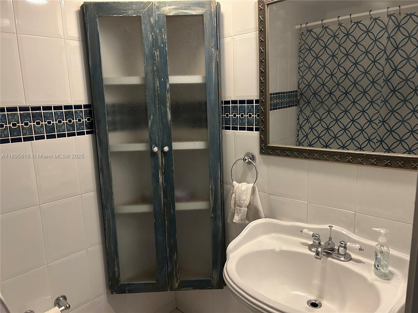 9411 Southwest 4th Street, Unit 202 Miami, FL 33174 - Photo 20 of 20 a bathroom with a sink and a mirror