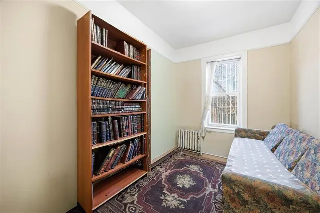 a bedroom with a bed and a book shelf