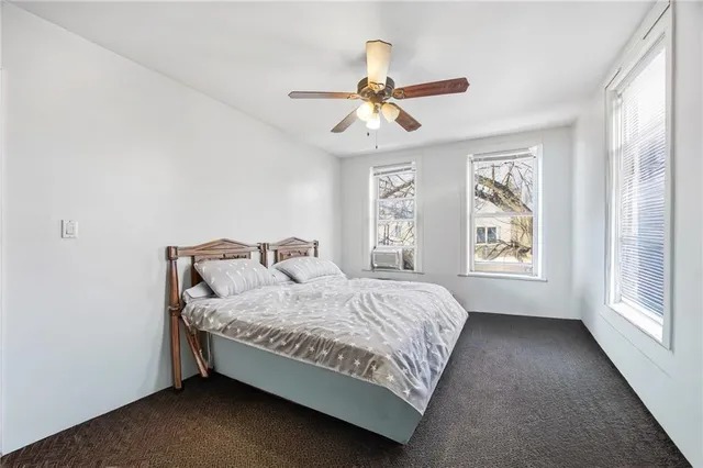 a bedroom with a bed and window