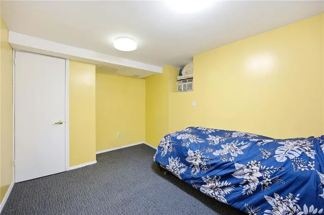 a bedroom with a bed and dresser