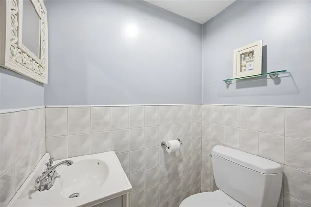 a bathroom with a sink and mirror with toilet
