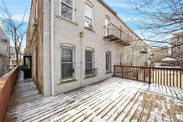 a picture of a room with a white wall and a large window