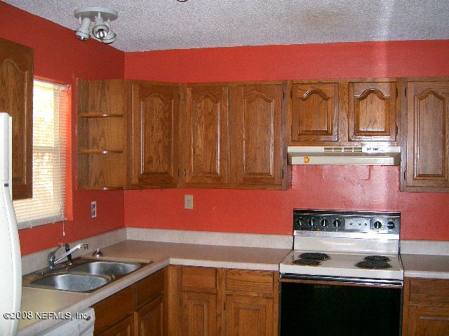 144 Katnack Road St. Augustine, FL 32095 - Photo 6 of 7 a kitchen with a stove and a sink
