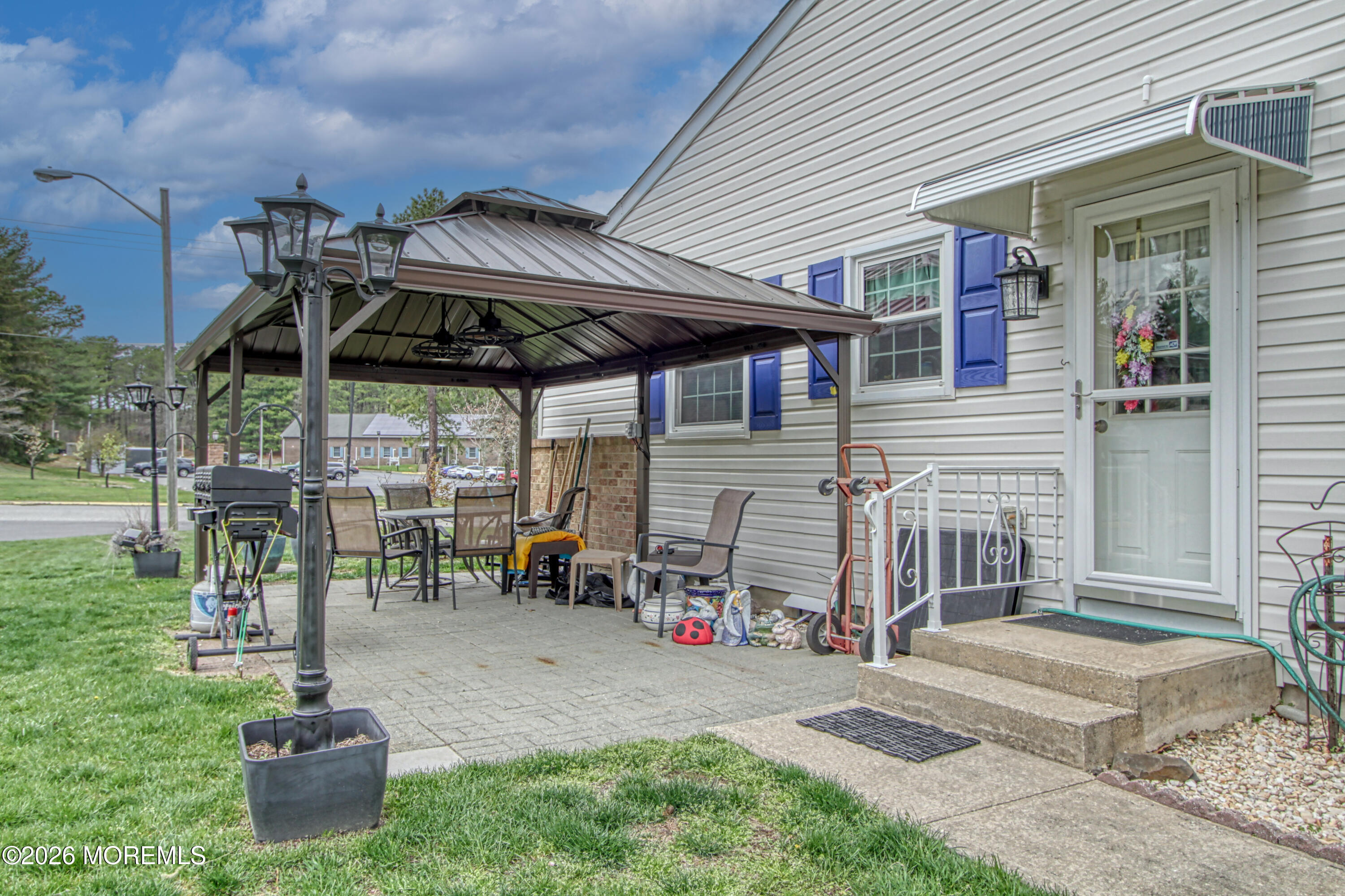 2B Amherst Road, Unit A Whiting, NJ 08759 - Photo 13 of 16 a view of a chair and table in backyard of the house