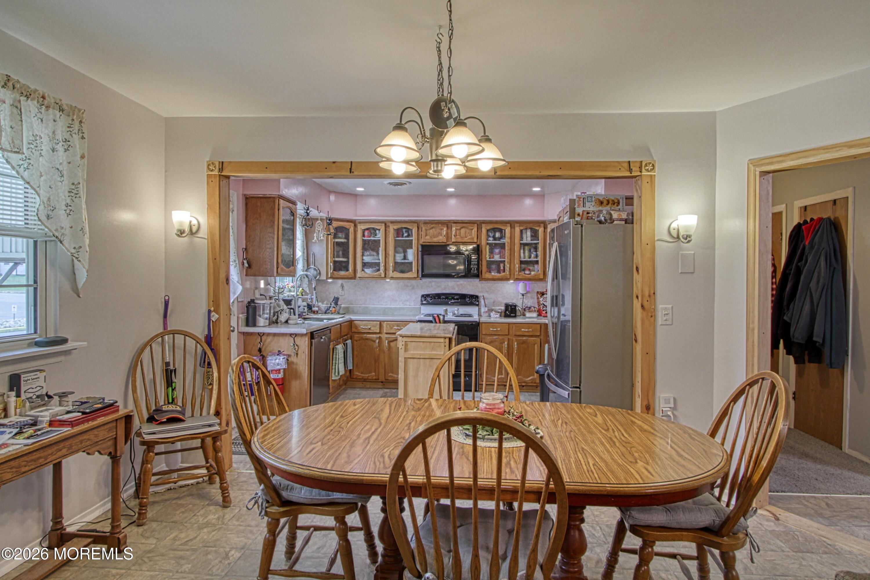 2B Amherst Road, Unit A Whiting, NJ 08759 - Photo 3 of 16 a view of a dining room with furniture and a chandelier
