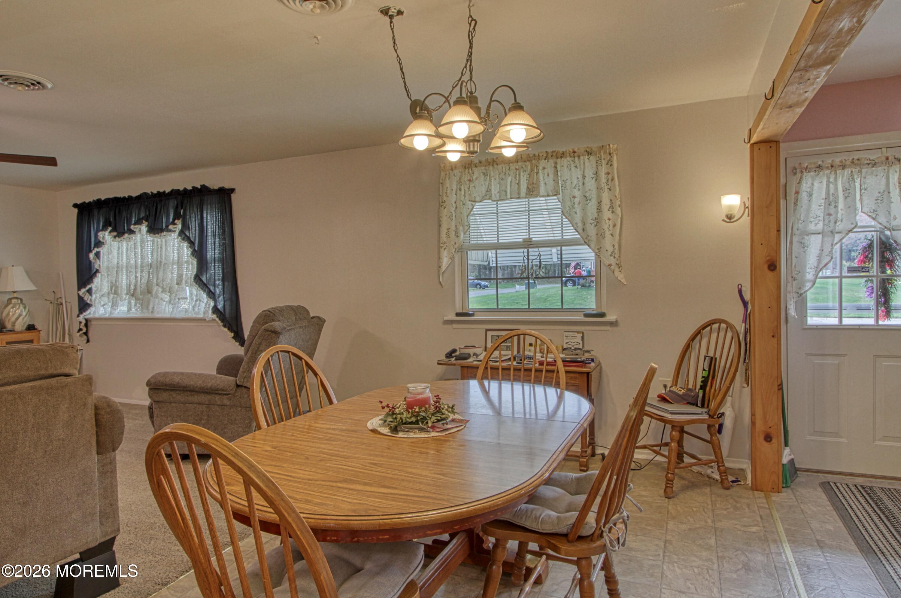2B Amherst Road, Unit A Whiting, NJ 08759 - Photo 4 of 16 a view of a dining room with furniture and chandelier