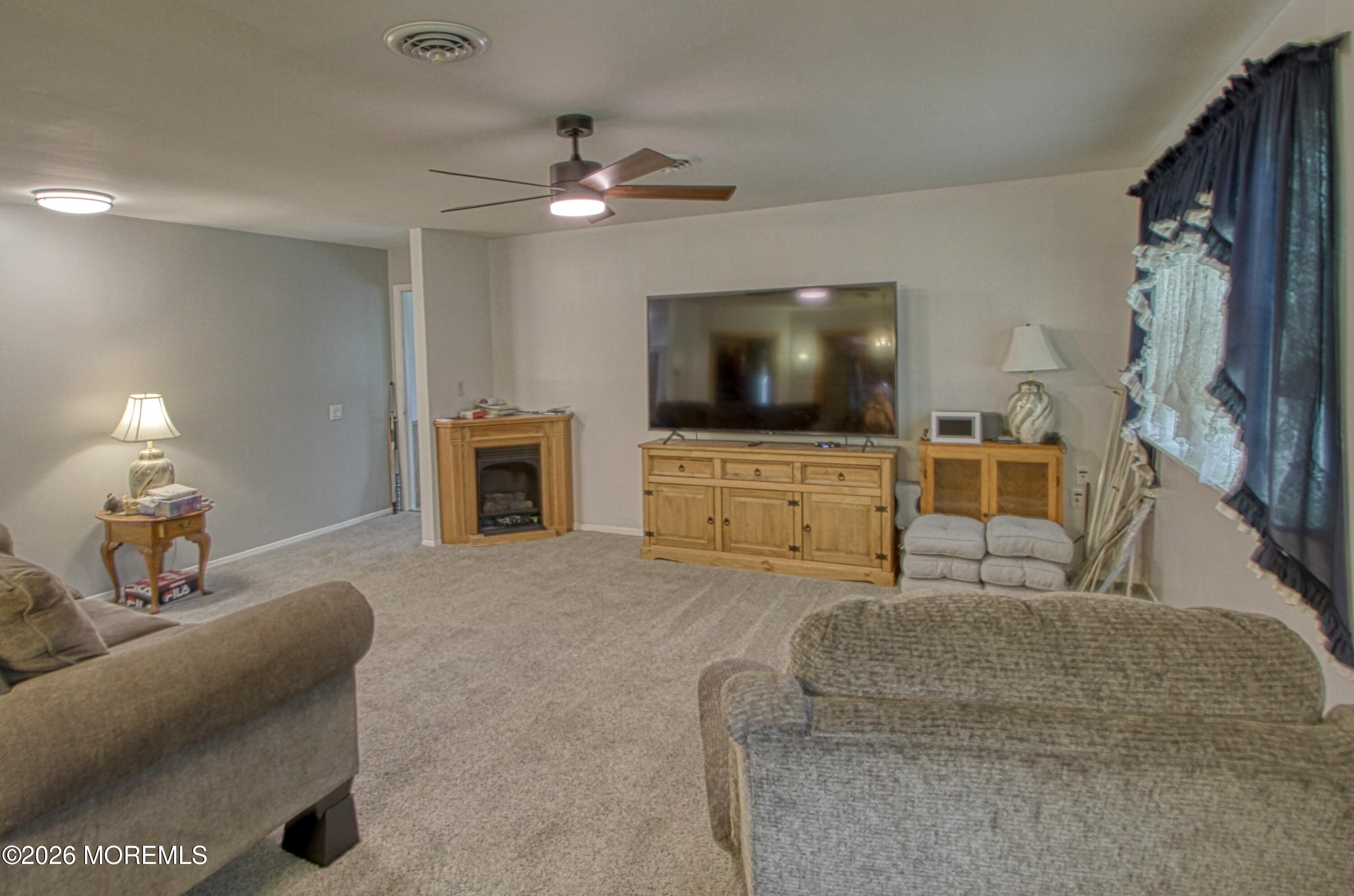 2B Amherst Road, Unit A Whiting, NJ 08759 - Photo 5 of 16 a living room with furniture and a flat screen tv