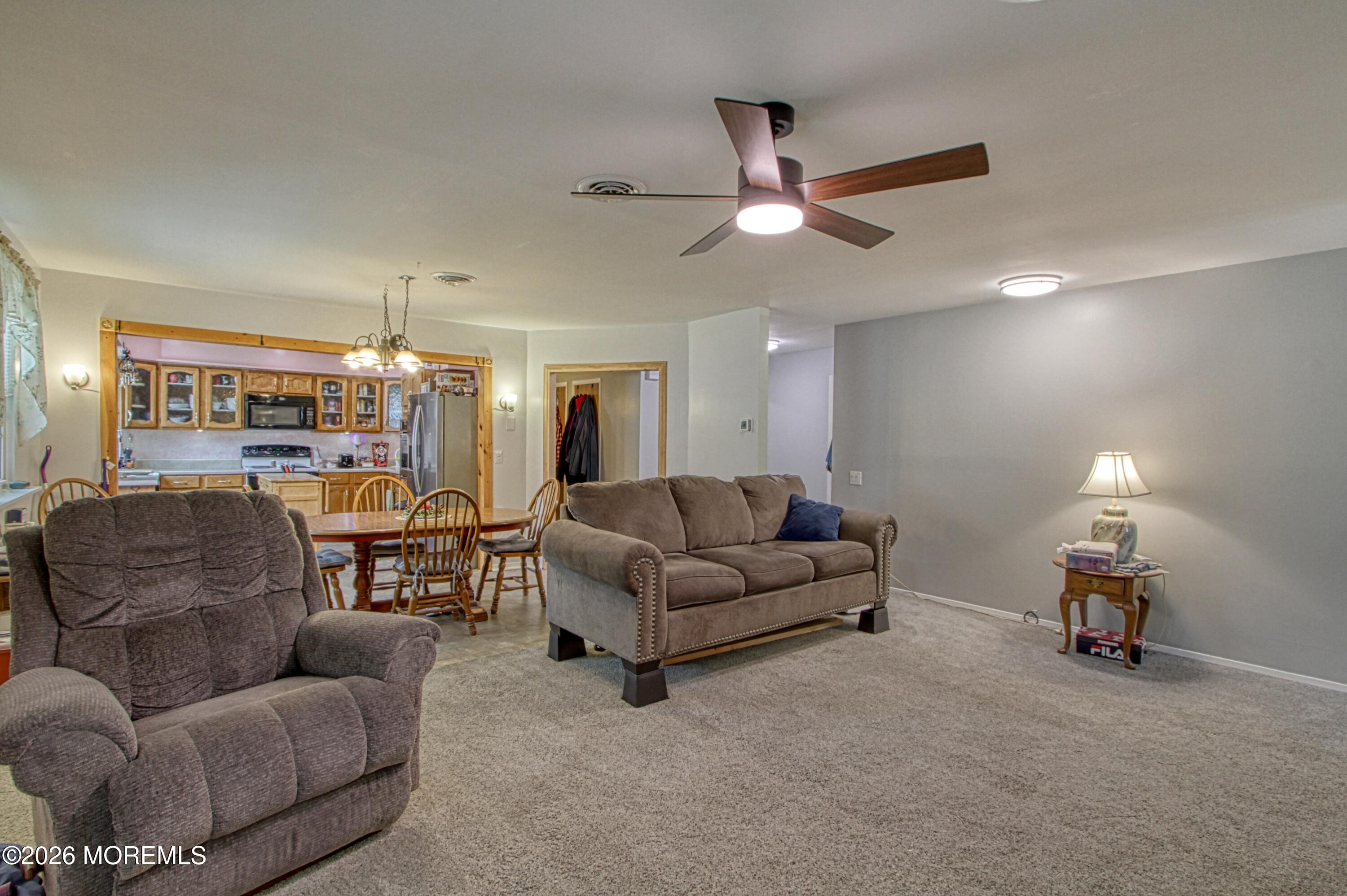 2B Amherst Road, Unit A Whiting, NJ 08759 - Photo 6 of 16 a living room with furniture and a chandelier