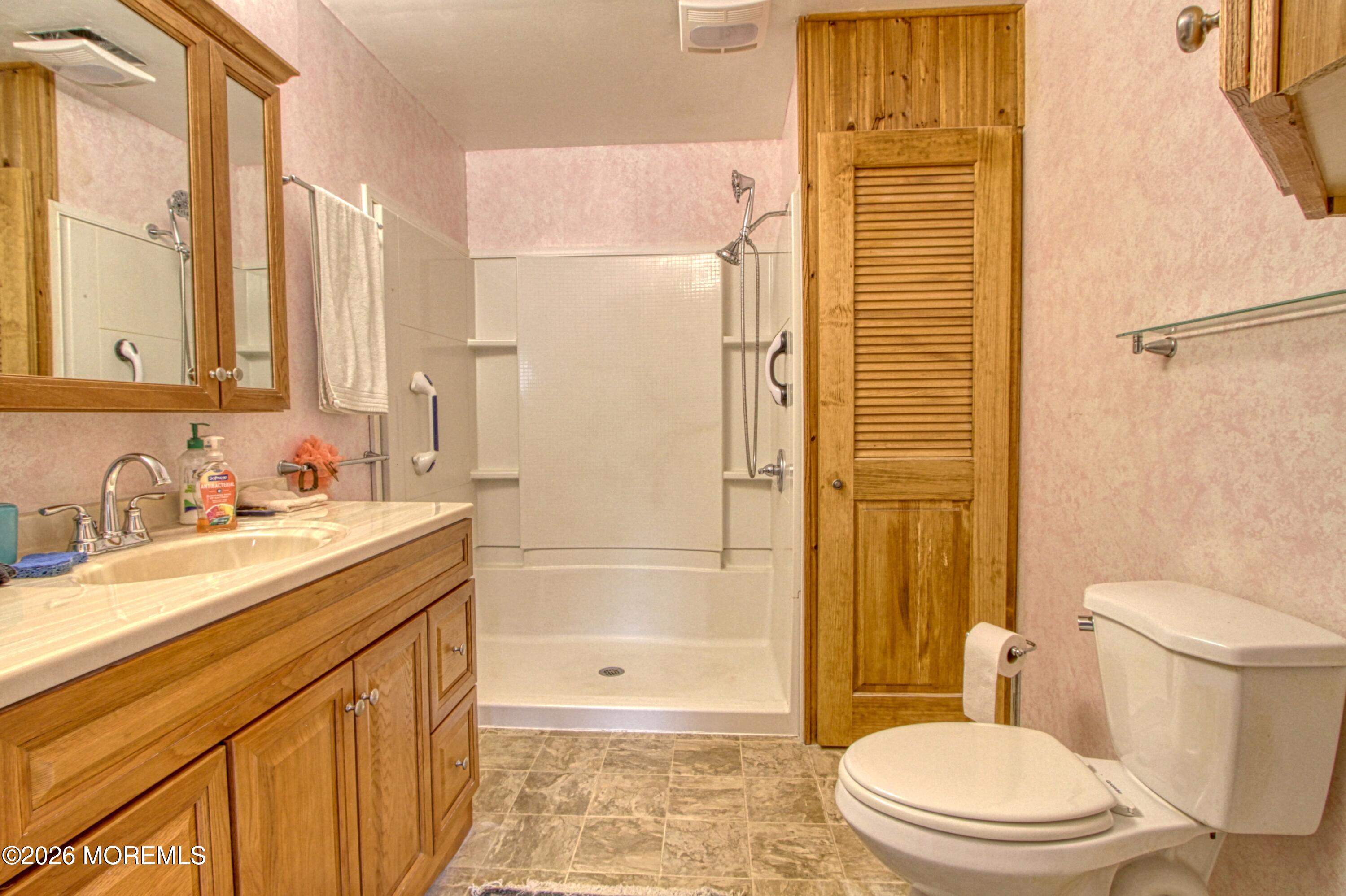 2B Amherst Road, Unit A Whiting, NJ 08759 - Photo 8 of 16 a bathroom with a granite countertop sink toilet and shower