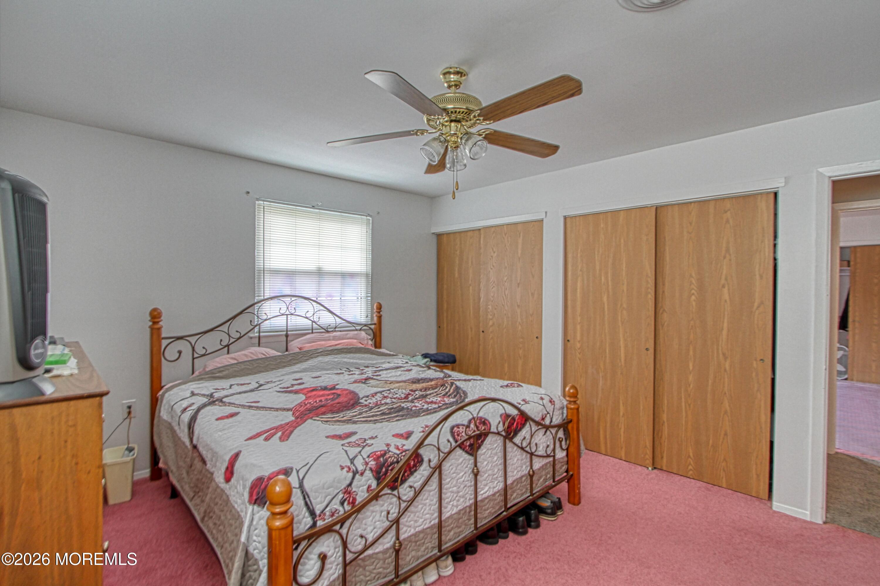 2B Amherst Road, Unit A Whiting, NJ 08759 - Photo 9 of 16 a bedroom with a bed and a chandelier