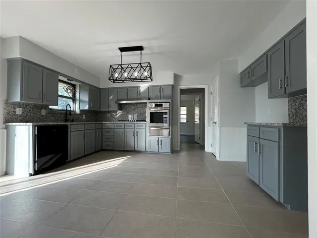 a kitchen with stainless steel appliances a refrigerator and a sink