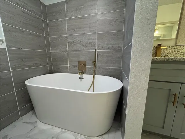 a white bath tub sitting in a bathroom