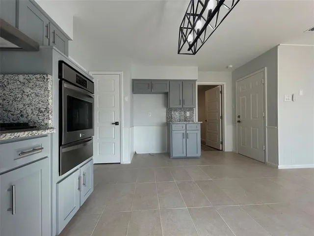 a view of kitchen cabinets and refrigerator