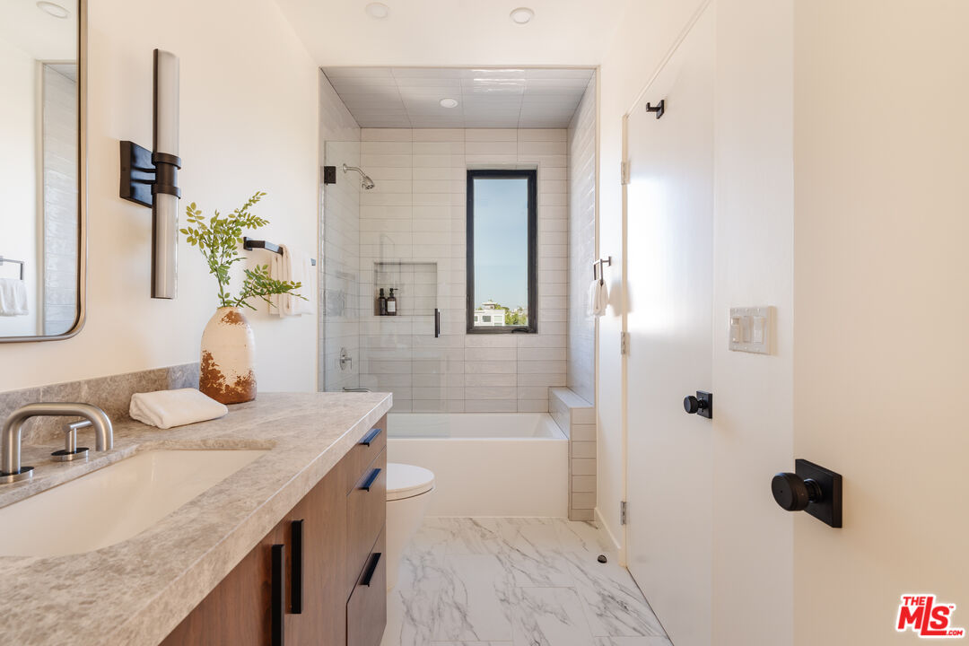 726 Howard Street Marina del Rey, CA 90292 - Photo 23 of 47 a bathroom with a granite countertop sink a mirror and shower