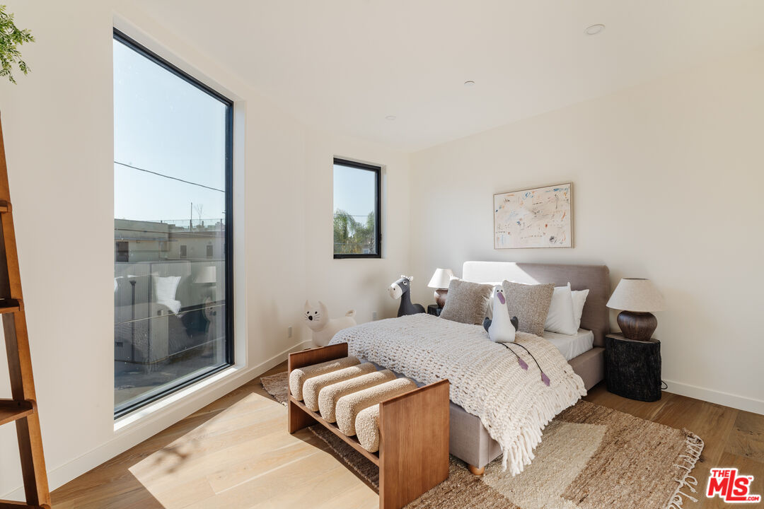 726 Howard Street Marina del Rey, CA 90292 - Photo 25 of 47 a bedroom with a bed and a large mirror next to a window