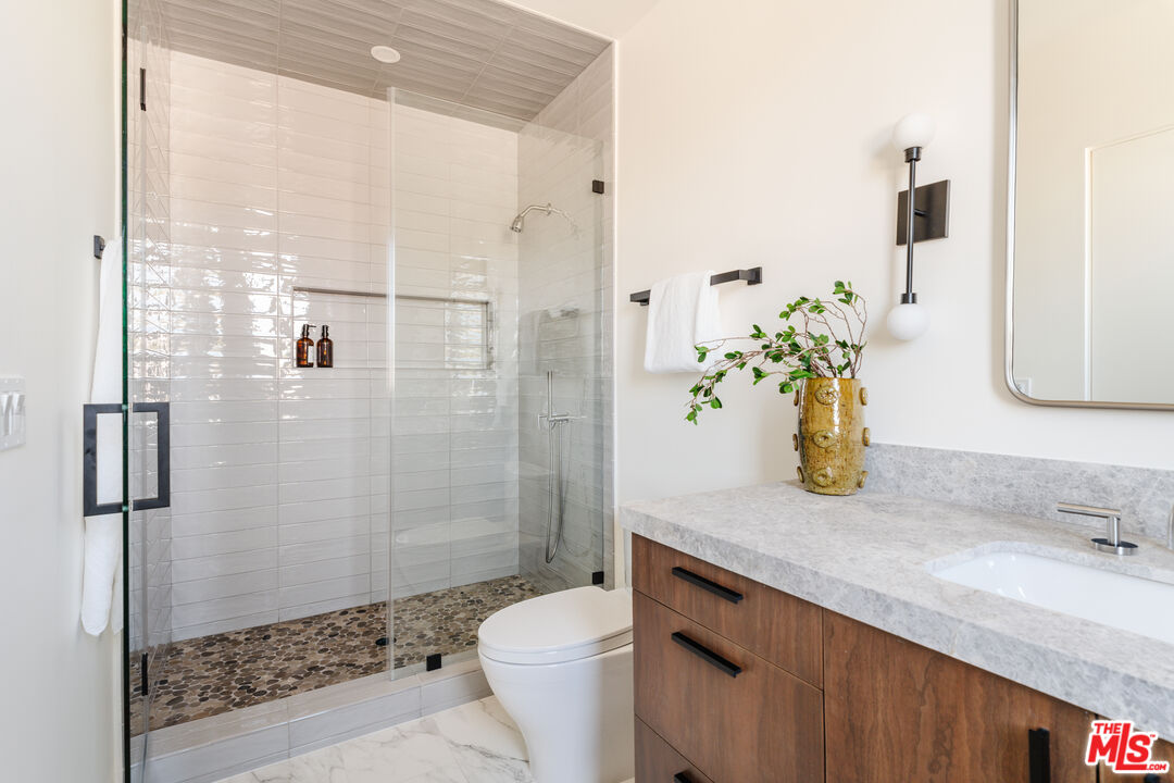 726 Howard Street Marina del Rey, CA 90292 - Photo 28 of 47 a bathroom with a granite countertop sink a toilet and shower