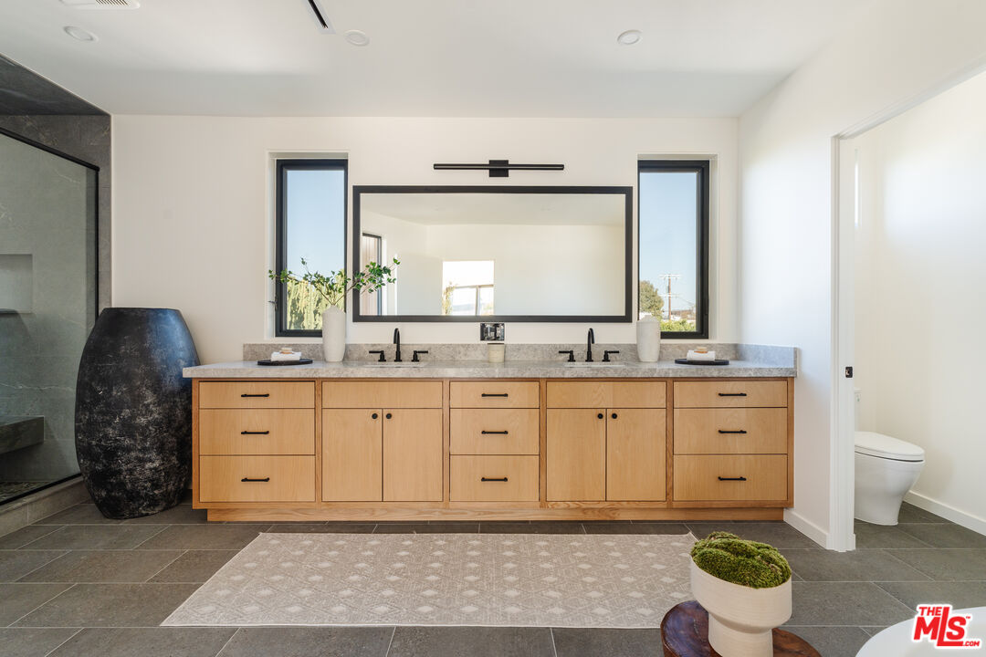 726 Howard Street Marina del Rey, CA 90292 - Photo 33 of 47 a spacious bathroom with a granite countertop sink and a mirror